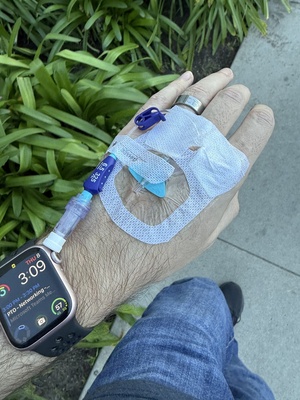 Walking with an IV pole between hospital imaging areas during pneumonia treatment.
